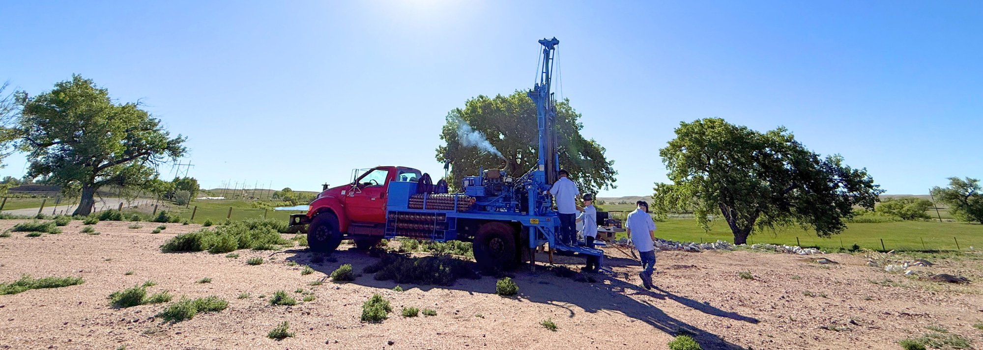 Horizontal crop of JB Drilling drill and team working